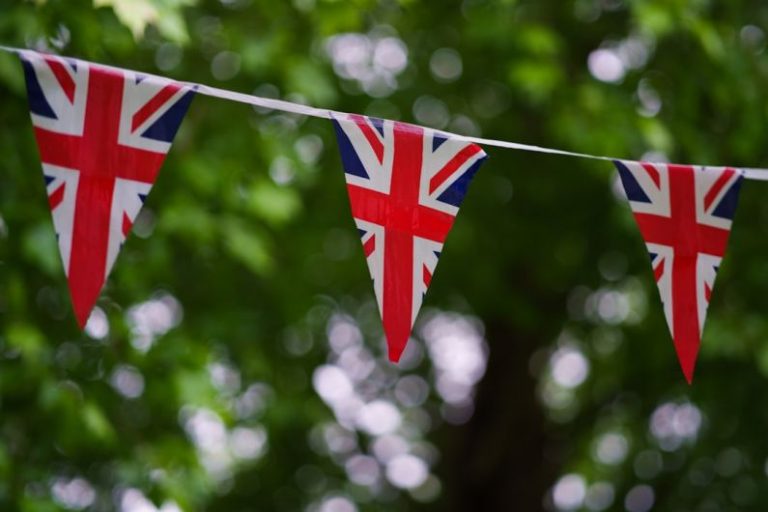 UK Property Market - a british flag bunting on a tree line