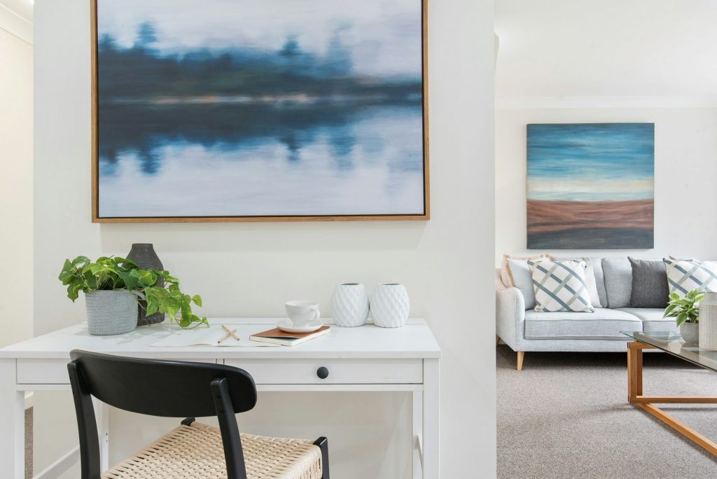 white-and-black-table-with-chairs-near-body-of-water-painting